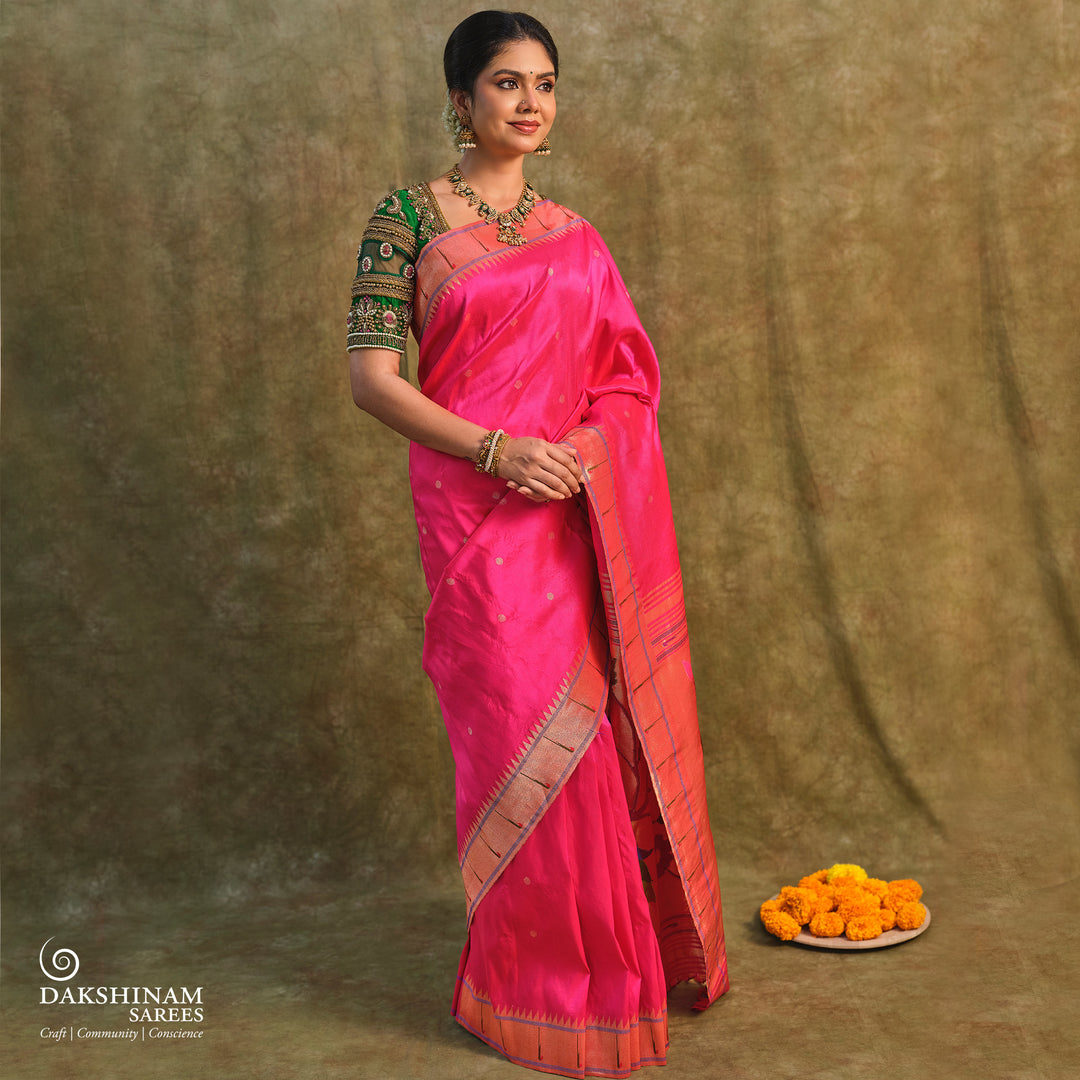 Pink Paithani silk saree with gold zari dotted body, tissue border with Munia motifs and multicolor parrot pallu.