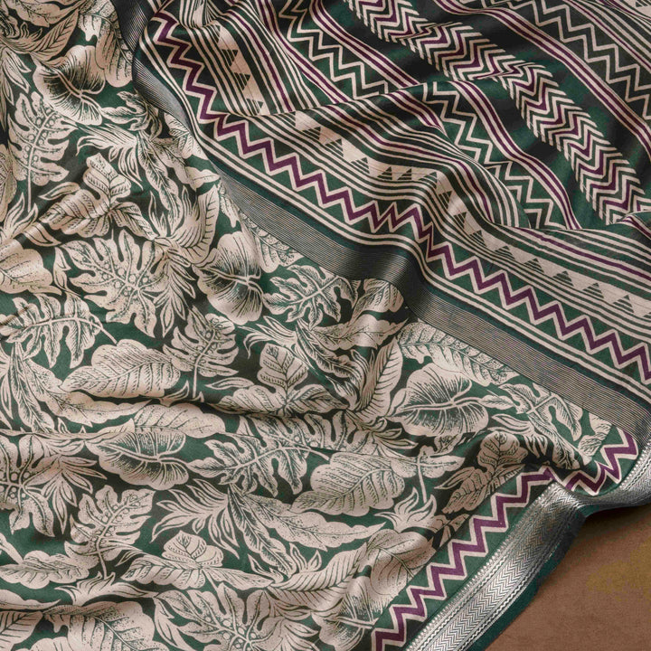 Green Chanderi silk cotton saree with white leaf print, silver zari border and striped pallu