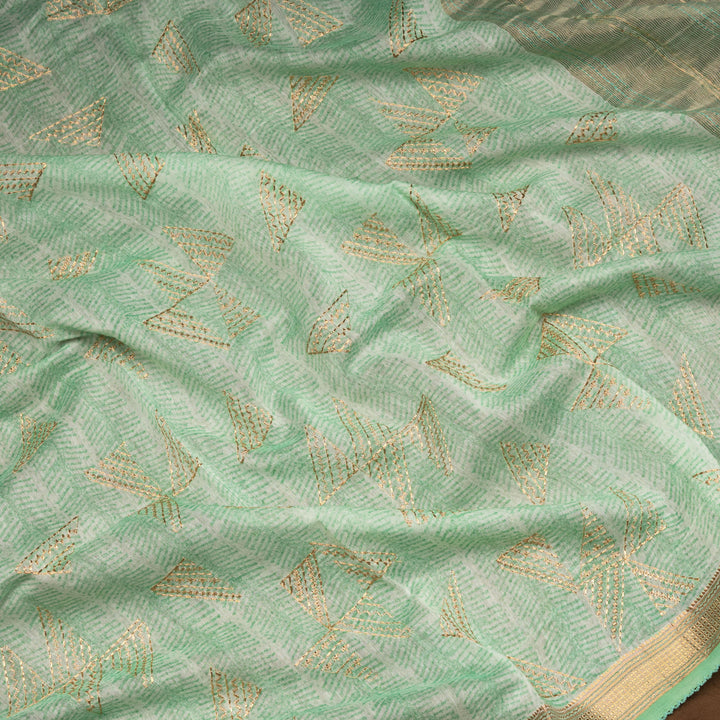 Green Chanderi silk cotton saree with gold zari geometric patterns and embroidered lace border