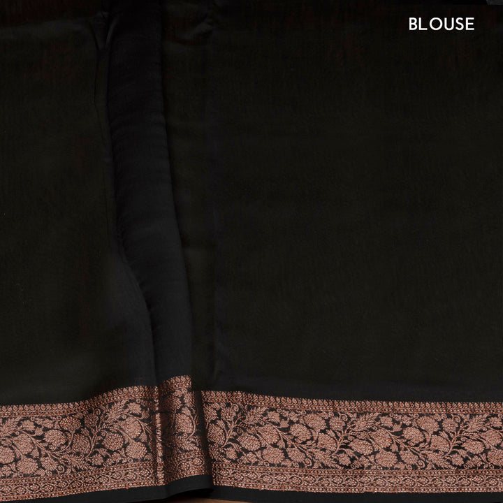 Black Chanderi silk cotton saree with white lotus floral print, gold zari border and orange striped pallu