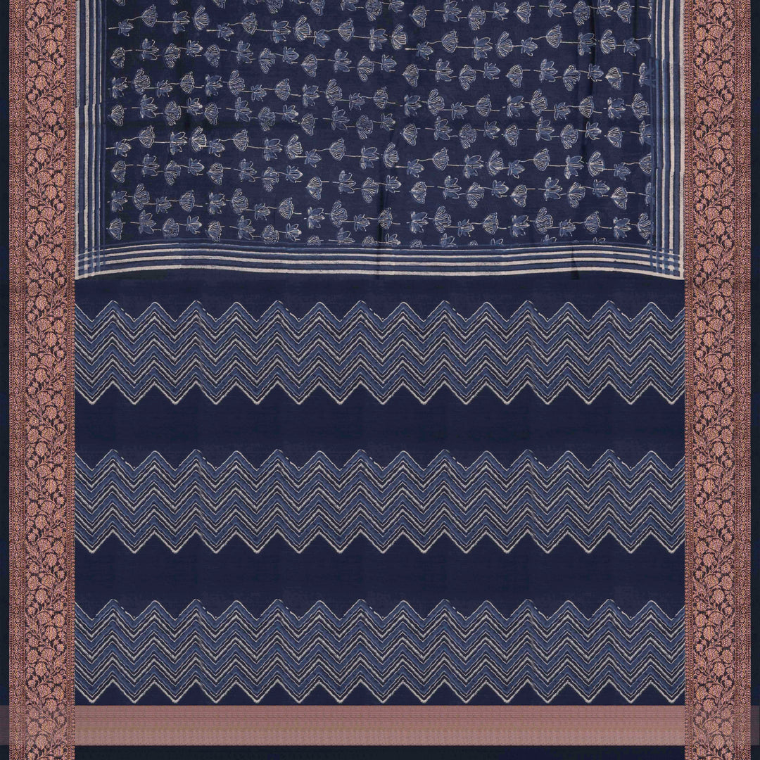 Dark blue Chanderi silk cotton saree with white lotus floral print, silver zari border and striped pallu
