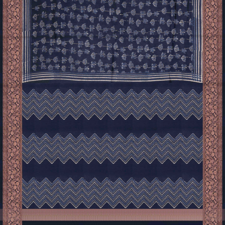 Dark blue Chanderi silk cotton saree with white lotus floral print, silver zari border and striped pallu