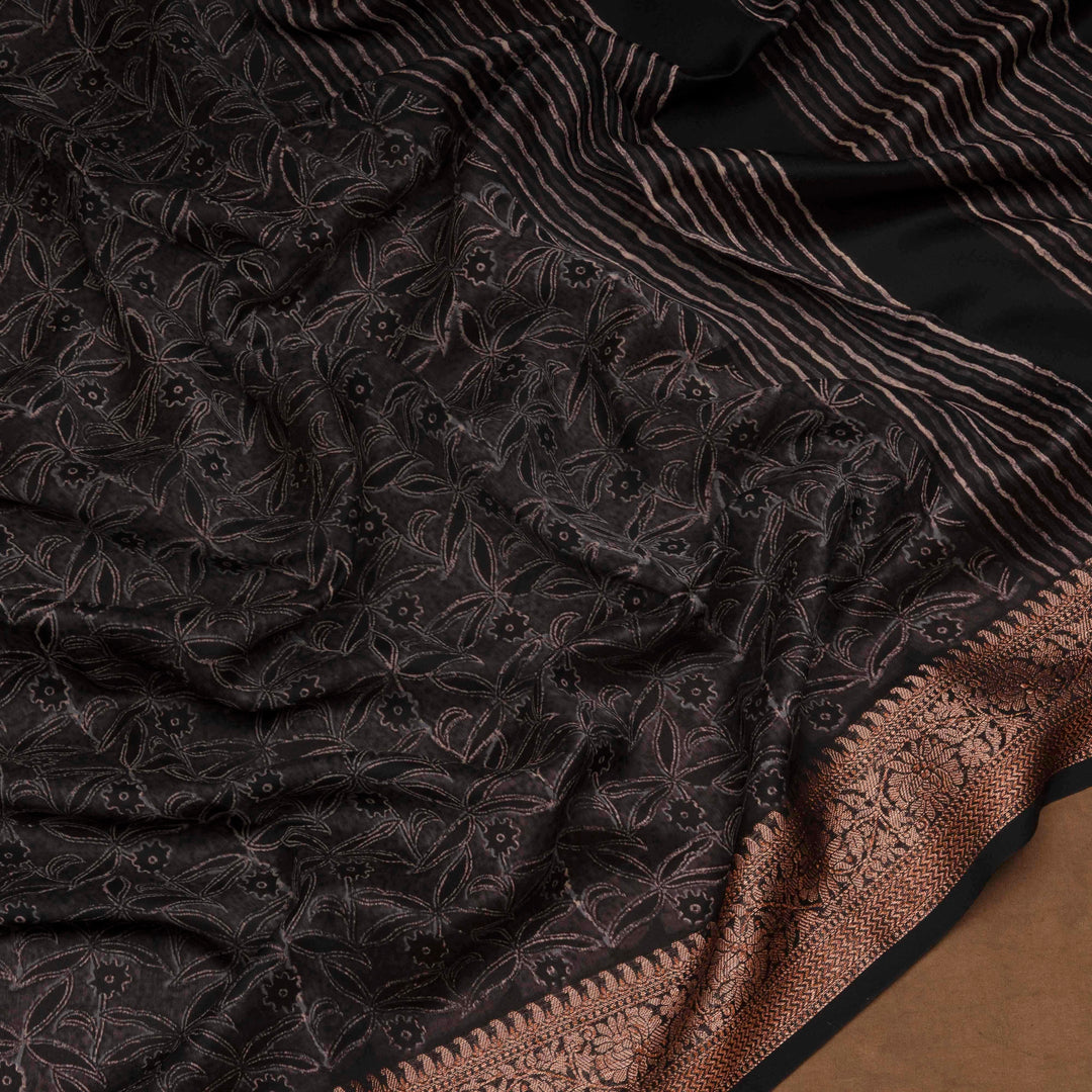Black Chanderi silk cotton saree with white floral print, gold zari border and striped pallu