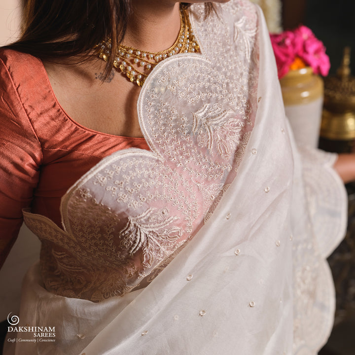 Closeup OF Handwoven White embroidered organza silk Saree