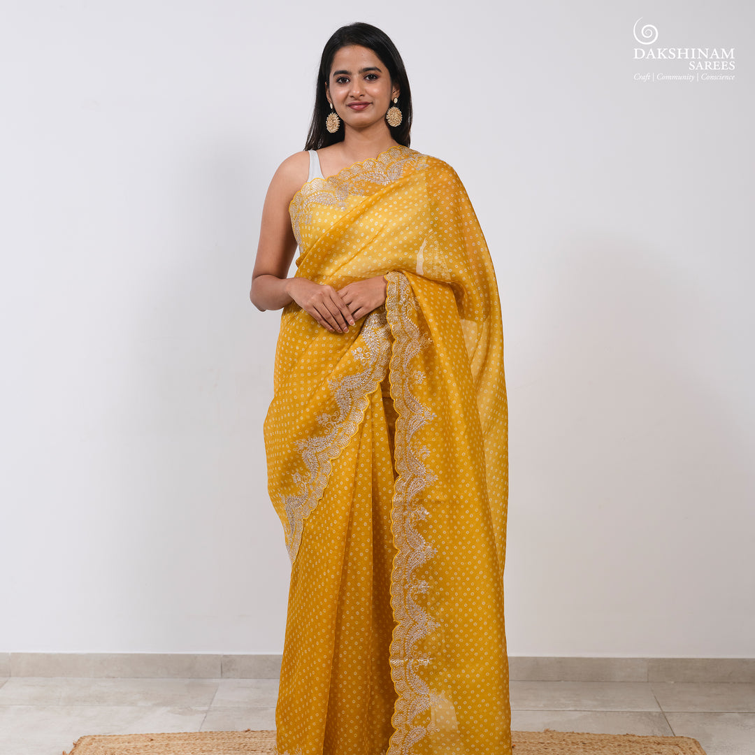 Body design of Handwoven Yellow Bandhini with embroidered organza silk Saree