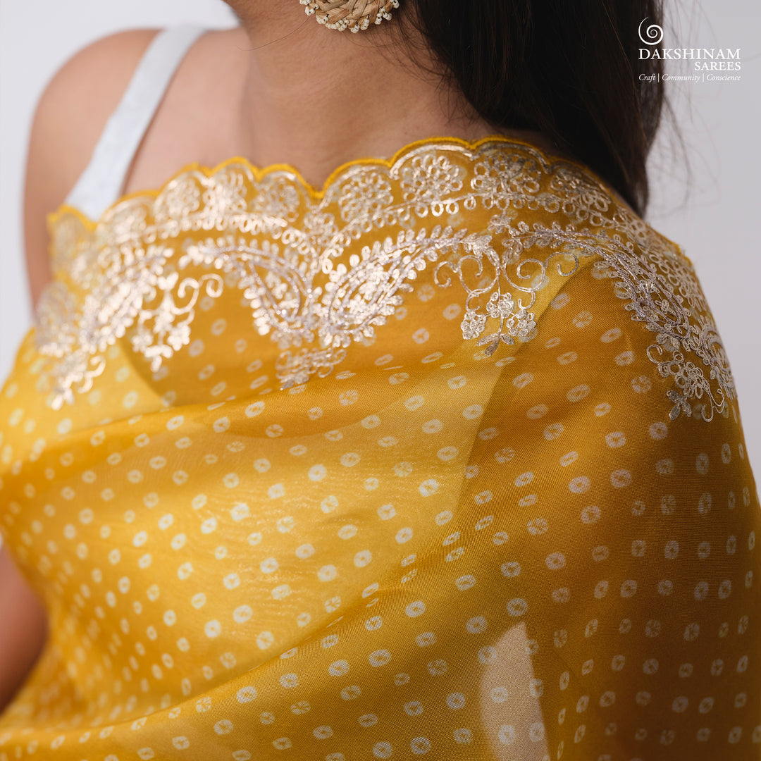 Closeup of Handwoven Yellow Bandhini with embroidered organza silk Saree