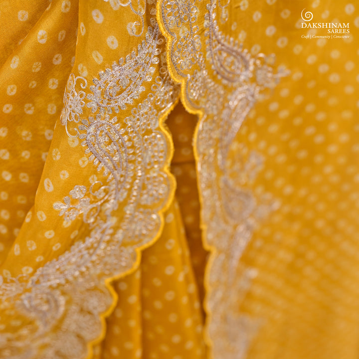Closeup of Handwoven Yellow Bandhini with embroidered organza silk Saree